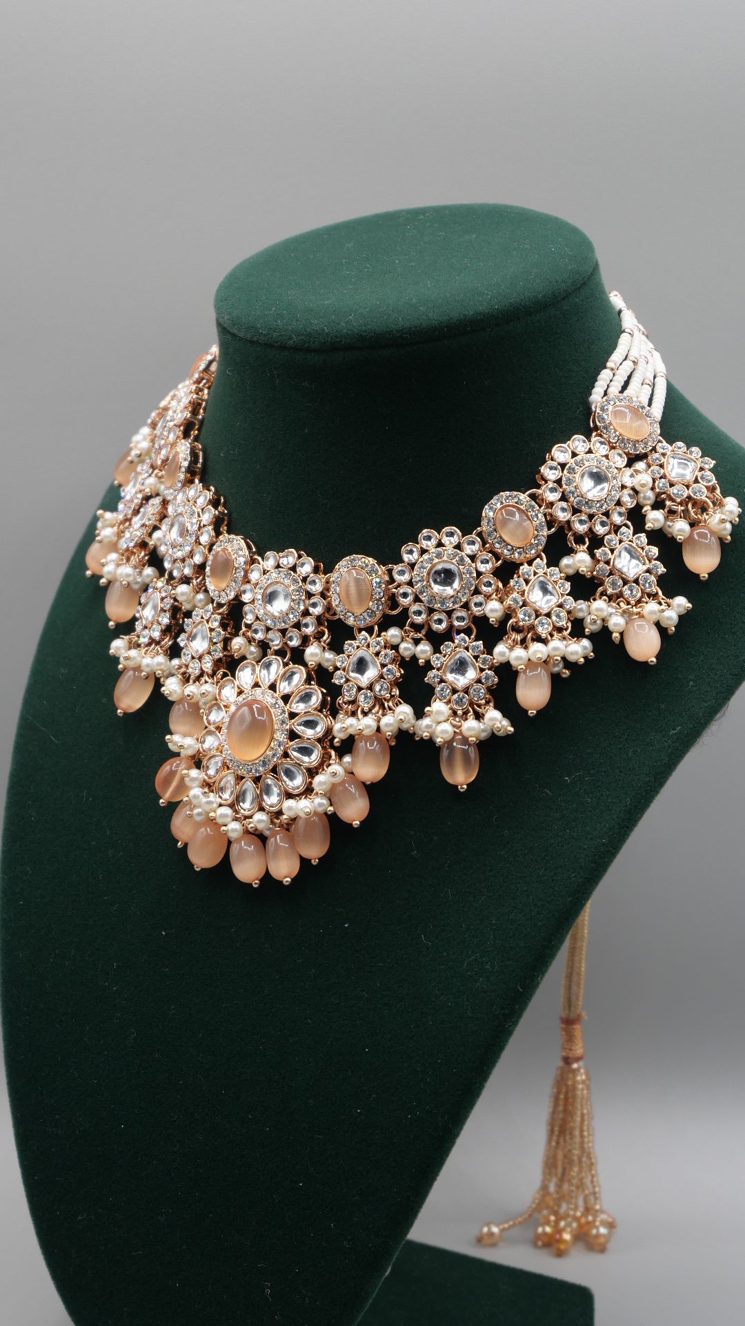 Corvus - Peach Kundan Necklace Set with white pearl chain in the back. Comes with matching Tikka and Earrings