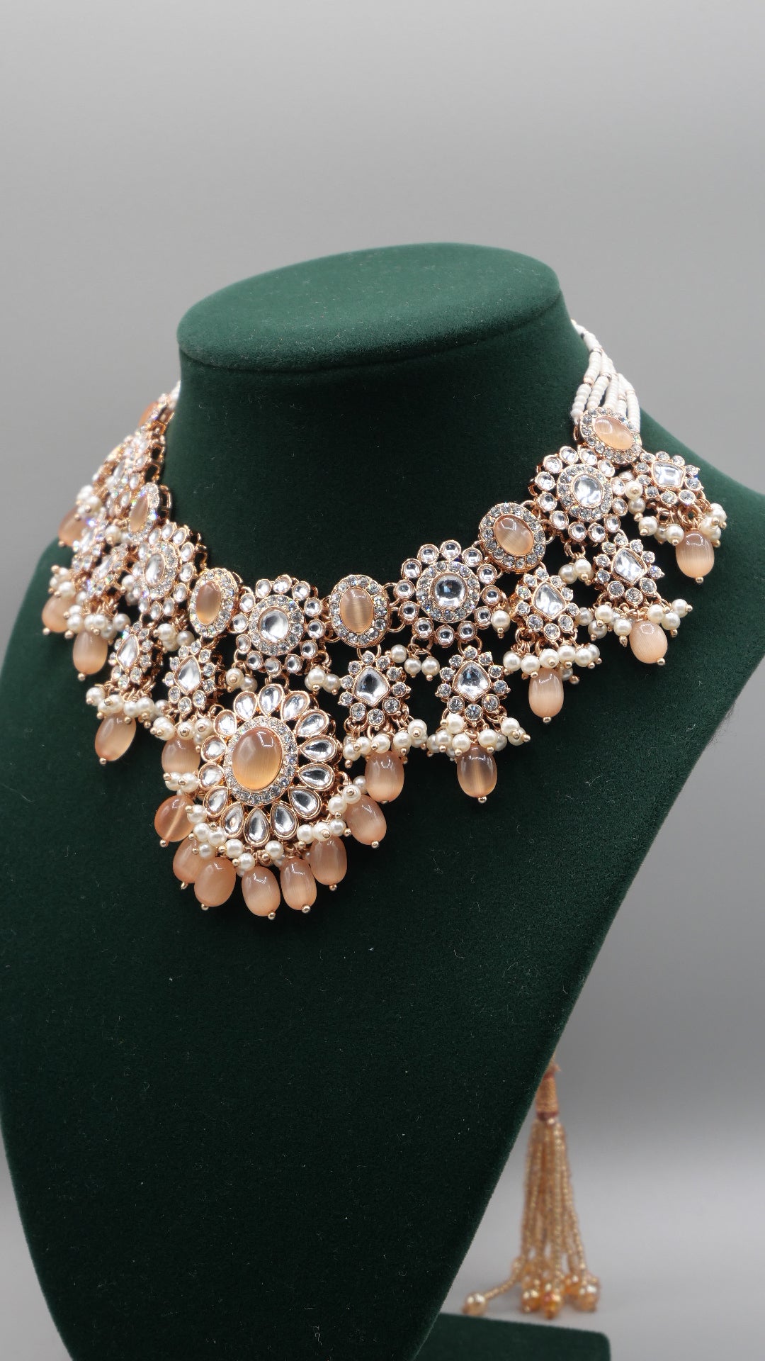 Corvus - Peach Kundan Necklace Set with white pearl chain in the back. Comes with matching Tikka and Earrings