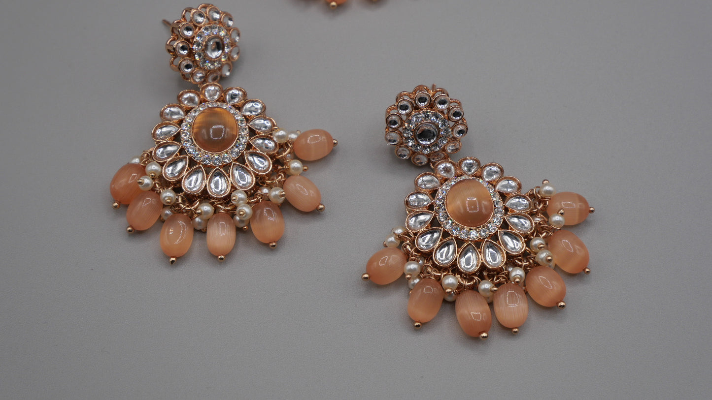 Corvus - Peach Kundan Necklace Set with white pearl chain in the back. Comes with matching Tikka and Earrings