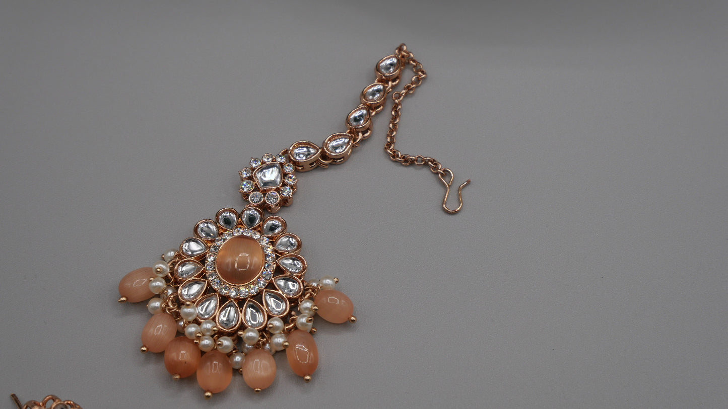 Corvus - Peach Kundan Necklace Set with white pearl chain in the back. Comes with matching Tikka and Earrings