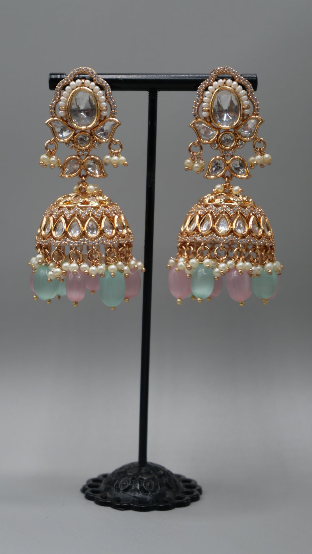 Aurora - A sophisticated Tyaani Kundan set featuring stunning pearl accents and dangling green and pink beads for a captivating display. Includes Jhumka earrings (2.4 inches)