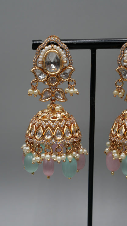 Aurora - A sophisticated Tyaani Kundan set featuring stunning pearl accents and dangling green and pink beads for a captivating display. Includes Jhumka earrings (2.4 inches)